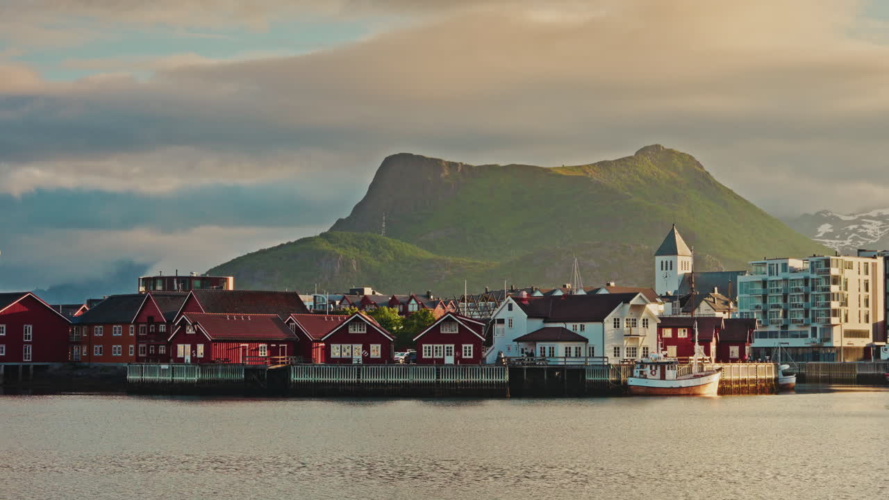 Midnight sunset in Svolvaer, Lofoten, Norway.
Picturesque nordic landscape at golden hour. Peaceful atmosphere. Nordic town.
