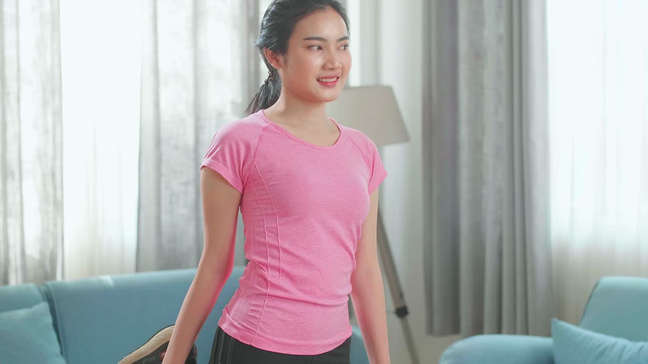 Asian Woman Exercising At Home, Stretching Her Legs