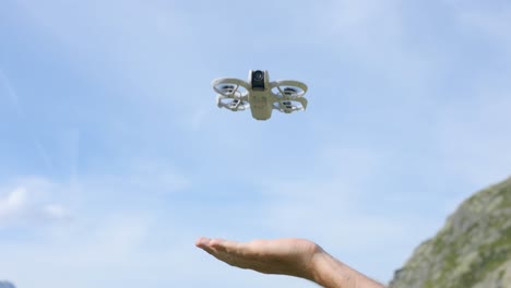 ultralight drone landing on palm of hand