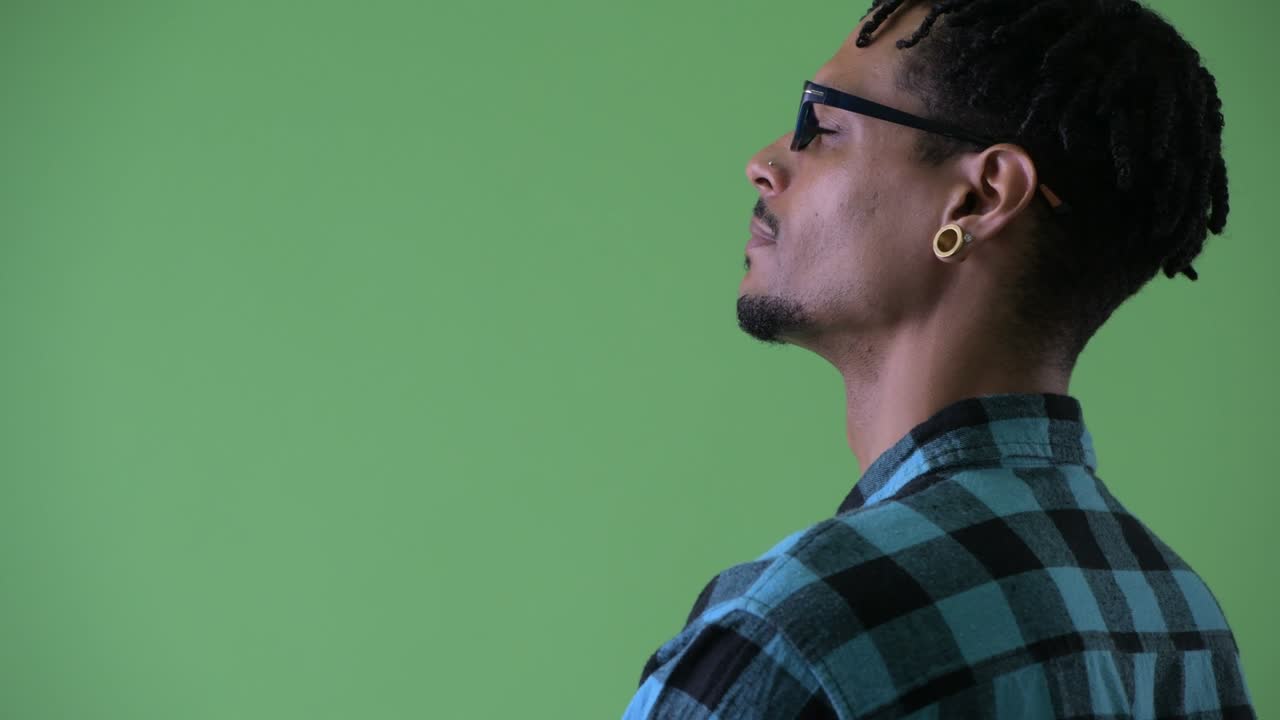 Happy young handsome African hipster man with dreadlocks