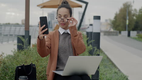 businesswoman taking a selfie outdoors