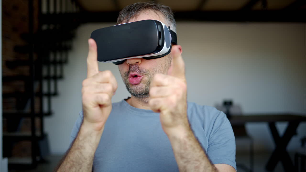 Man wearing black VR virtual reality headeset and playing