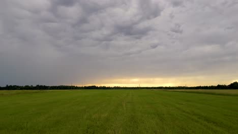 Closeup-flight-over-green-summer-field-in-Munich,-Germany