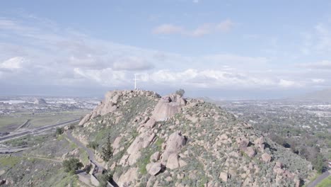 Drone-pans-from-hilltop-cross-to-American-flag