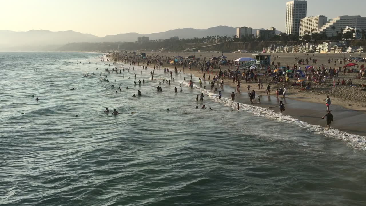 Beach at Santa Monica, California with crowd at sunset