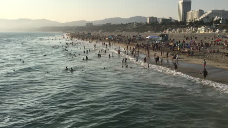 beach at santa monica, california with crowd at sunset