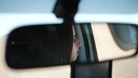 a woman looking around in her car and observing the surroundings