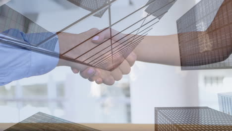 tall buildings against mid section of businessman and businesswoman shaking hands