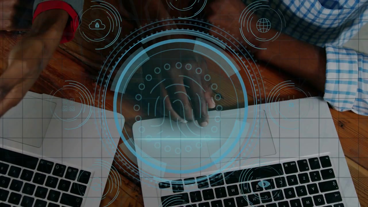 African American men pointing and using laptop trackpad on wooden table, showing DATA PROTECTION