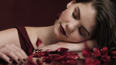 portrait-beautiful-caucasian-woman-relaxing-rose-petals-falling-on-soft-skin-sensual-female-dreaming-of-intimate-fantasy-romance-indulging-desire-in-red-valentines-day-concept