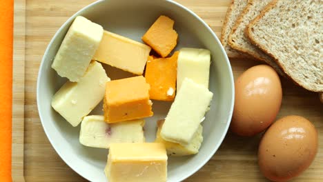 cheese cubes green, yellow and red  on chopping board