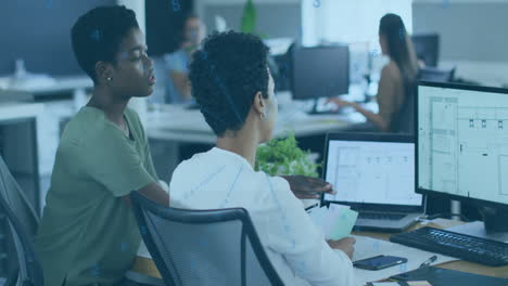 two colleagues discussing project over digital data animation in modern office