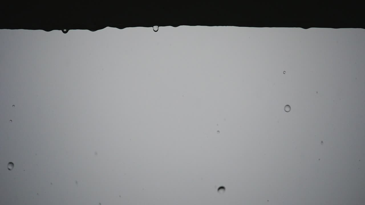 Rain Drops Falling from the ledge