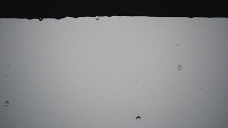 rain drops falling from the ledge