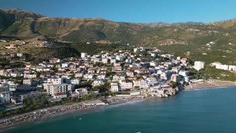 Aerial-Pullback-Reveals-Albanian-Riviera-Coastal-Town-of-Himare,-Albania