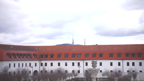 courtyard of bratislava castle with trees and fountains in winter.