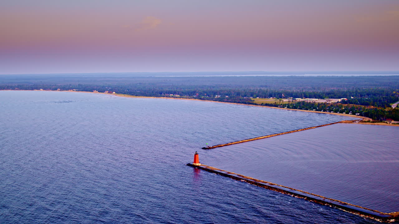 Drone shot flying over lake Michigan panning from the city of Manistique to lake michigan