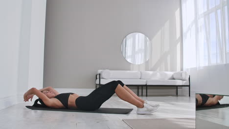 home fitness concept. woman doing abs crunches on floor at home copy space