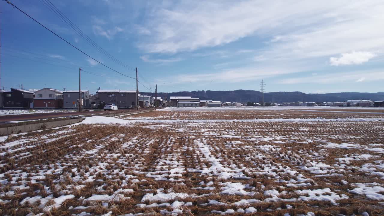 Peaceful winter landscape showing farmland patterns and small village houses