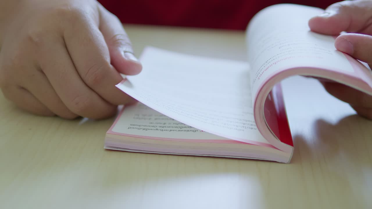 Flipping through pages engaging reading experience at a cozy desk close-up view book exploration