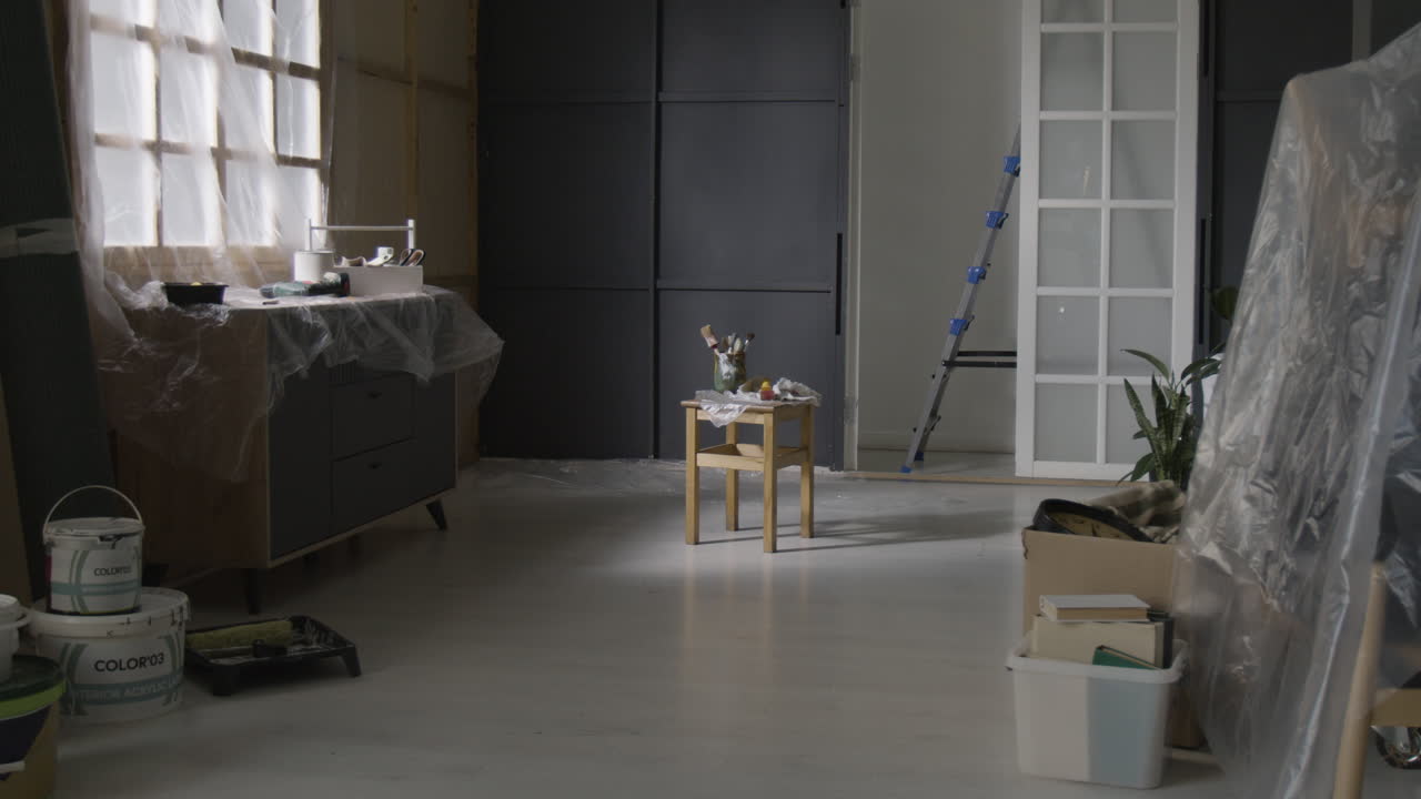 Room renovation with furniture and painting equipment