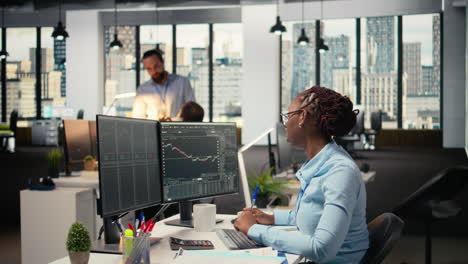 day trader analyzes stock market price charts, taking notes