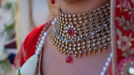 indian bride wearing gold-plated crystal red and white choker necklace