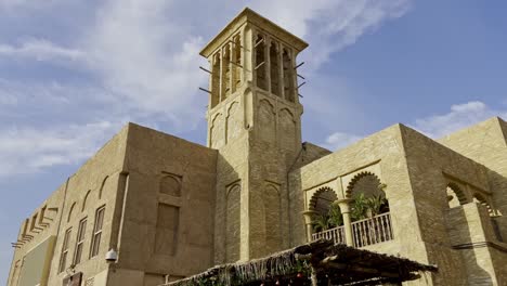 Amazing-Historical-Buildings-In-Al-Fahidi,-Dubai-in-United-Arab-Emirates---panning-tilt-up-shot