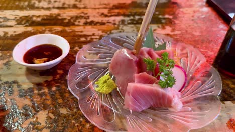 enjoying fresh sashimi with soy sauce