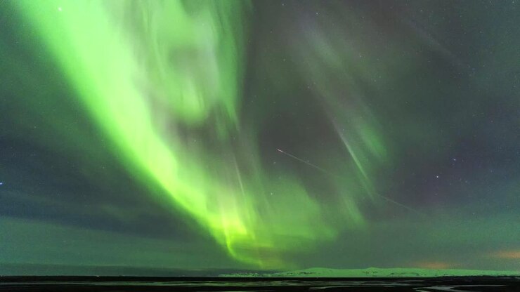 Amazing Northern lights in night sky over mountains