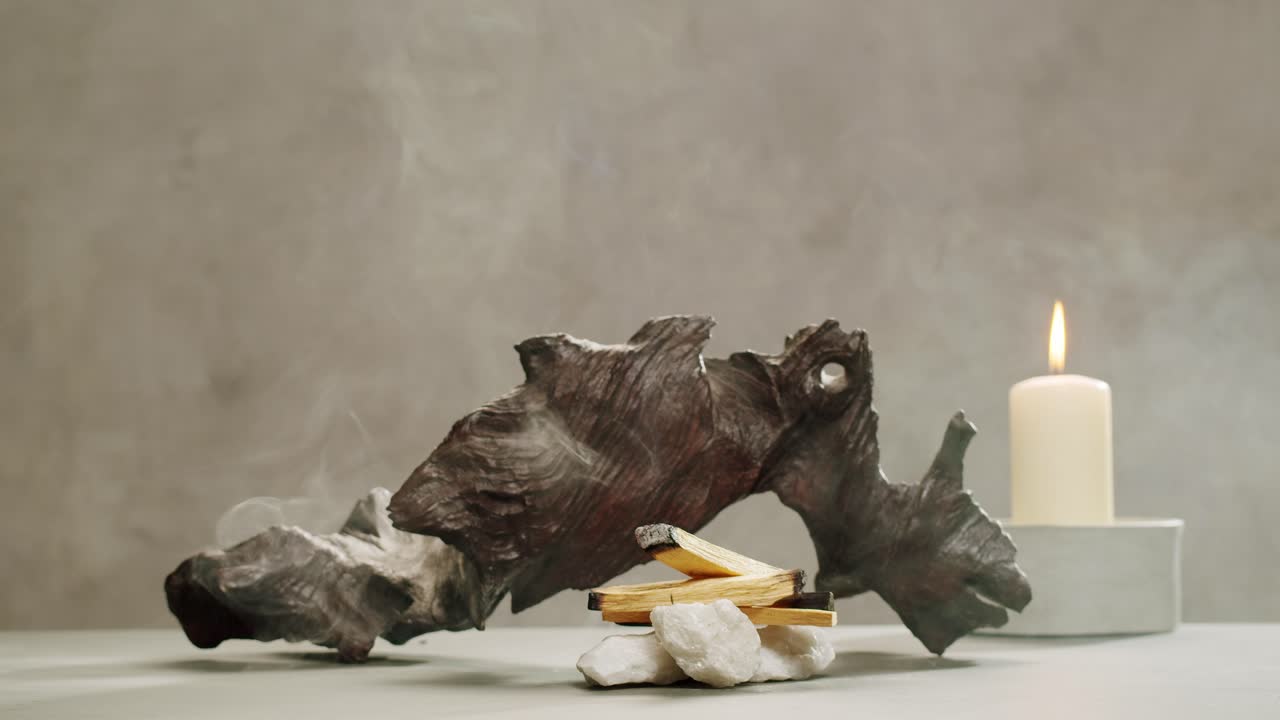 Person holding Palo Santo wood stick in hand, aromatic Palo Santo burning on black background, smoke spreading around, slow motion video clip, high quality 4k close up footage. High quality 4k footage