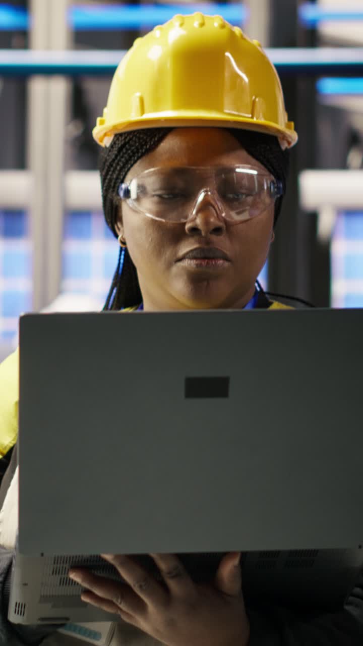 Vertical video Solar panels factory engineer analyzing data from IoT sensors