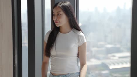 woman at window overlooking city