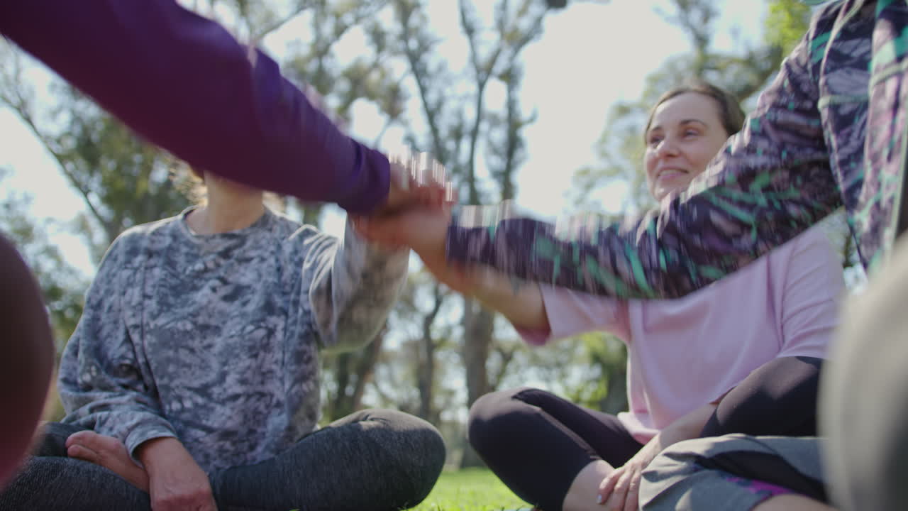Women in a Circle Connecting Hands in a Park