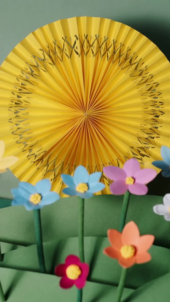 Vertical video: Sliding camera revealing craft table, bringing rosette and pastel blooms close