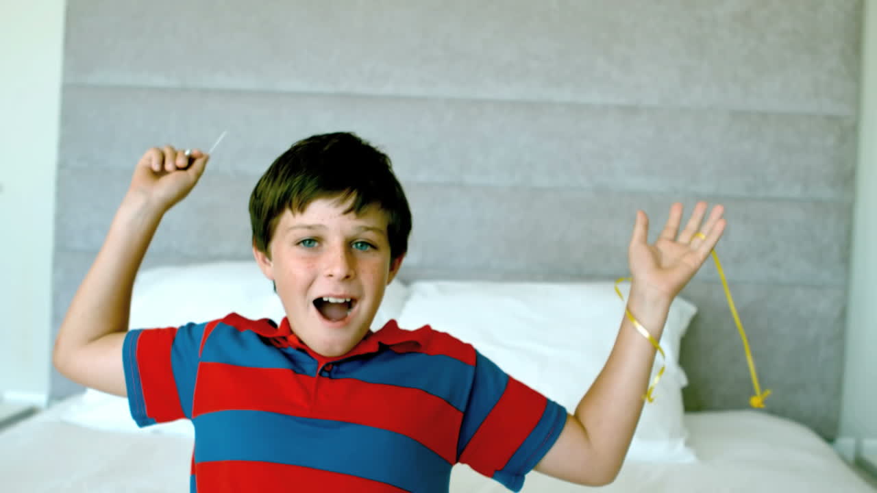 Boy piercing his yellow balloon and getting a fright