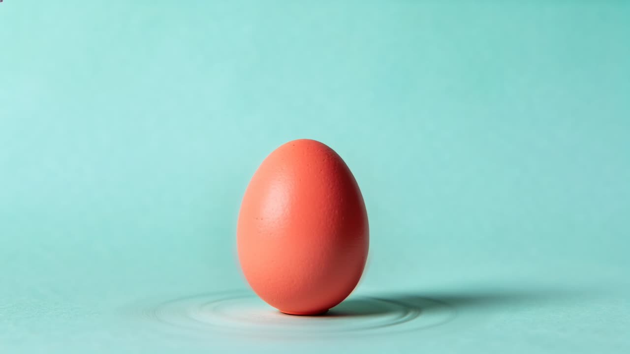 Shifting frame nudging orange egg moving toward center on mint set, ripple expanding for centering