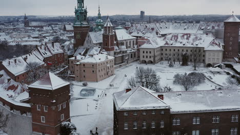 snow-covered wawel castle at cloudy morning, krakow, poland