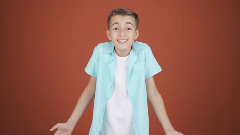 Boy-clapping-excitedly-to-camera.