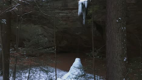 hocking hills state park ash cave with frozen waterfall and ice cone during winter in ohio, usa
