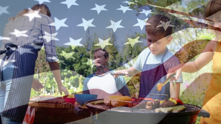 Caucasian family doing barbecue with US flag waving foreground
