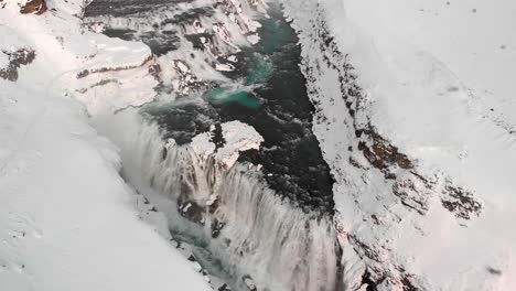 drone shot of gullfoss waterfall in iceland during winter