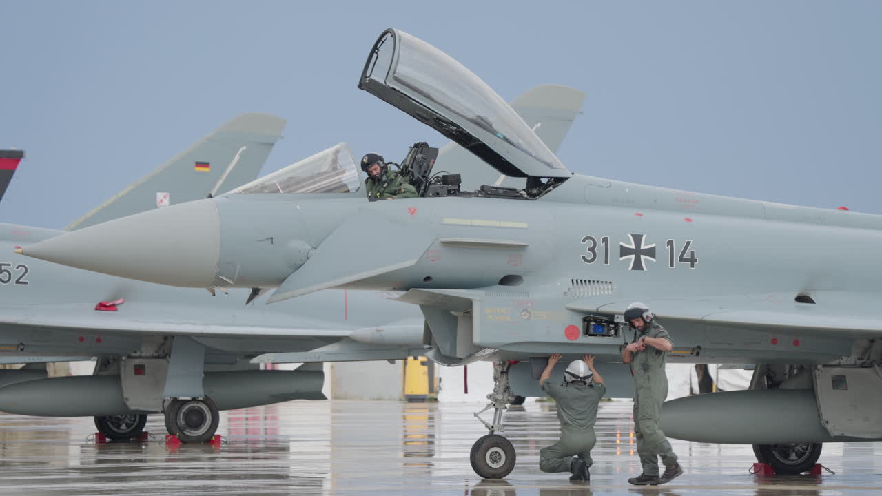 Military Personnel Preparing Eurofighter Typhoon Fighter Jets on Tarmac