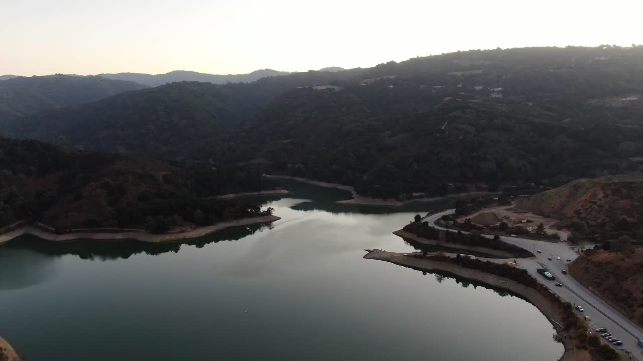 Top view of Steven's Creek Reservoir Lakeshore, with a road and cars on the right side at Cupertino, California