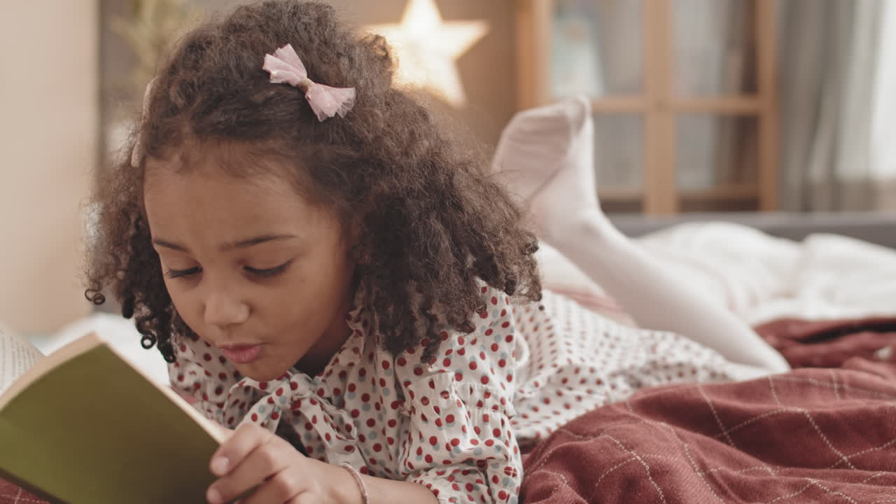 Curly Girl Reading Book in Bed