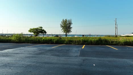 Public-access-area-on-Muskegon-Lake,-drone-taking-flight,-POV