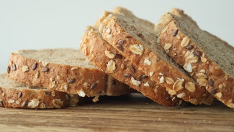 sliced multigrain bread on wooden board