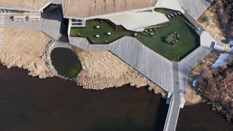 Above-modern-outdoor-spa-in-Iceland-on-shore-of-Lake,-sunny-day