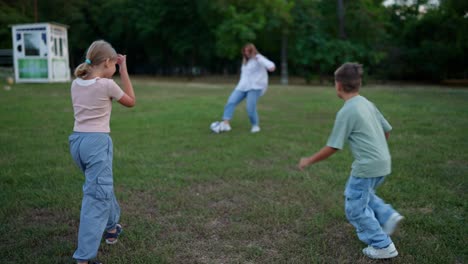 family playing soccer in the park