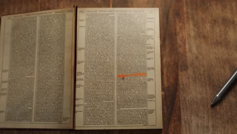 3d animation showing a zooming out view of an old book with highlighted text on a wooden table